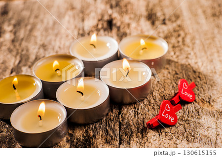 Burning candles sparkle like stars on a dark surface Burning candles sparkle like stars on a dark surface 130615155