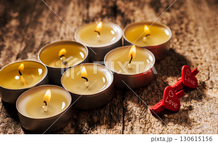 Tealight candles shine steadily on the brown background Tealight candles shine steadily on the brown background 130615156