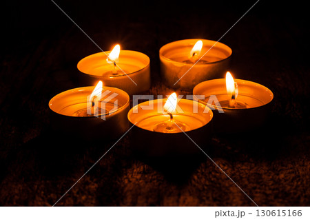 Small candles burn together, forming a wave of warmth Small candles burn together, forming a wave of warmth 130615166