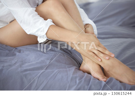 Skincare, smooth and hair removal with legs of woman in bedroom for wellness, beauty and pedicure. Shaving, waxing and epilation with girl on bed at home for cosmetics, glow and clean treatment Skincare, smooth and hair removal with legs of woman in bedroom for wellness, beauty and pedicure. Shaving, waxing and epilation with girl on bed at home for cosmetics, glow and clean treatment 130615244