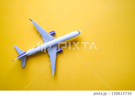 flat lay of airplane model on yellow background, travel and holidays concept flat lay of airplane model on yellow background, travel and holidays concept 130615710