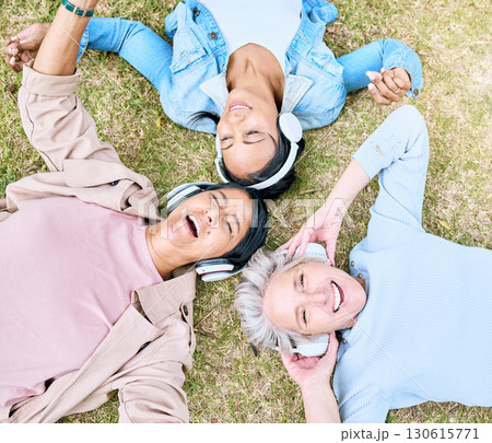 Top view, senior or women and music headphones in silent disco, retirement fun or bonding community wellness. Smile, happy or elderly friends lying on grass or listening to radio in relax nature park 130615771