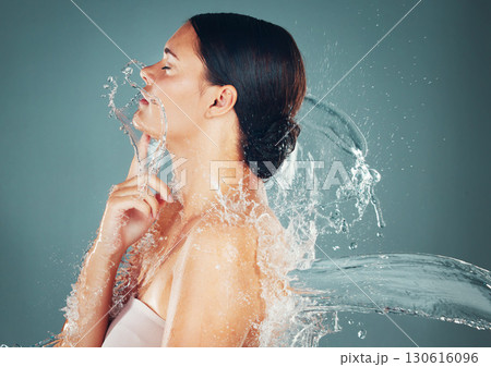Beauty, water and skincare splash on woman cleaning skin for hygiene and hydration isolated in a studio background. Self care, grooming and female dermatology for young beautiful adult Beauty, water and skincare splash on woman cleaning skin for hygiene and hydration isolated in a studio background. Self care, grooming and female dermatology for young beautiful adult 130616096