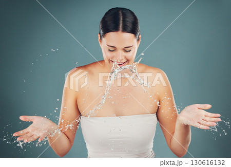 Skincare, beauty and water splash while washing face for cleaning and dermatology studio background. Health and wellness of a aesthetic model person with clean skin or body after facial spa treatment Skincare, beauty and water splash while washing face for cleaning and dermatology studio background. Health and wellness of a aesthetic model person with clean skin or body after facial spa treatment 130616132