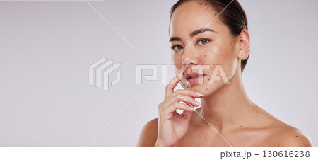 Beauty, skincare and portrait of asian woman in studio for cosmetics, dermatology and wellness. Aesthetic model person with makeup, mockup space and facial self care skin glow on grey background Beauty, skincare and portrait of asian woman in studio for cosmetics, dermatology and wellness. Aesthetic model person with makeup, mockup space and facial self care skin glow on grey background 130616238