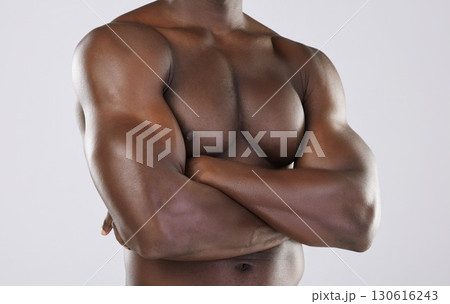 Naked body, skin and black man, arms crossed and muscle, strong with fitness isolated on studio background. Muscular, bodybuilder and natural cosmetics, clean and fresh with skincare and nude Naked body, skin and black man, arms crossed and muscle, strong with fitness isolated on studio background. Muscular, bodybuilder and natural cosmetics, clean and fresh with skincare and nude 130616243