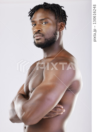 Confident, muscular and portrait of a black man with arms crossed isolated on a grey studio background. Fitness, health and African athlete with muscle, power and bodybuilding body on a backdrop Confident, muscular and portrait of a black man with arms crossed isolated on a grey studio background. Fitness, health and African athlete with muscle, power and bodybuilding body on a backdrop 130616248