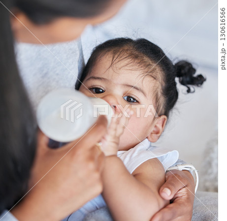 Baby drinking bottle, formula and nutrition with feeding and family, health and growth with early childhood development. Mother feed infant child milk, people at home with health and wellness 130616566