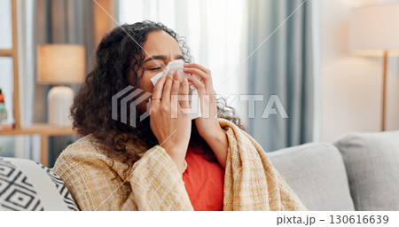 Sick, woman and blow nose in home for winter allergies, cold disease and virus infection. Flu, tissue paper and person in living room on sofa with blanket, bacteria and health problem with hay fever 130616639