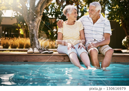 Senior couple, hug and swimming pool for holiday in relax for love or quality bonding time together on summer vacation. Happy elderly man holding woman relaxing with feet in water by the poolside Senior couple, hug and swimming pool for holiday in relax for love or quality bonding time together on summer vacation. Happy elderly man holding woman relaxing with feet in water by the poolside 130616979