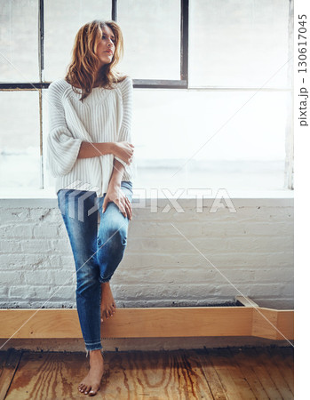 Thinking, fashion and window with a woman, barefoot in her home, standing next to mockup or flare. Motivation, idea and relax with an attractive young female leaning against a wall in her house 130617045