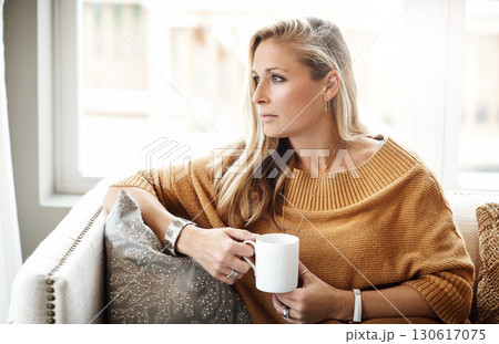 Woman, thinking and relax with coffee on sofa in living room for morning mindfulness peace, calm vision and planning lifestyle ideas in home. Female, thoughtful mindset and drinking warm tea on couch Woman, thinking and relax with coffee on sofa in living room for morning mindfulness peace, calm vision and planning lifestyle ideas in home. Female, thoughtful mindset and drinking warm tea on couch 130617075