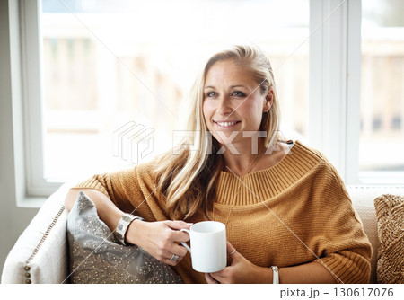 Woman, thinking and relax happy with tea on sofa in living room for morning mindfulness peace, calm vision and planning lifestyle ideas in home. Female, smile and mindset thought with coffee on couch Woman, thinking and relax happy with tea on sofa in living room for morning mindfulness peace, calm vision and planning lifestyle ideas in home. Female, smile and mindset thought with coffee on couch 130617076
