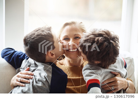 Kiss, happy and portrait of a mother with children for love, relax and bonding in a family home. Hug, smile and mom with affection for boy kids during quality time on the living room sofa of a house 130617096