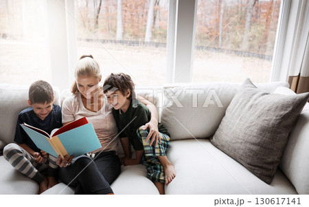 Books, reading and mother with kids on sofa for storytelling time in living room of happy home. Love, learning and woman with children, book and fantasy story on couch, growth and child development. Books, reading and mother with kids on sofa for storytelling time in living room of happy home. Love, learning and woman with children, book and fantasy story on couch, growth and child development. 130617141