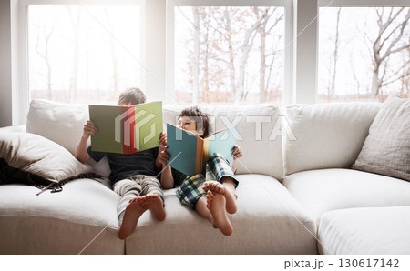Kids, bonding reading books in education, learning or relax studying on house living room or family home sofa. Happy children, storytelling or fantasy fairytale novel in hobby or creative inspiration Kids, bonding reading books in education, learning or relax studying on house living room or family home sofa. Happy children, storytelling or fantasy fairytale novel in hobby or creative inspiration 130617142