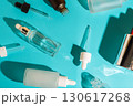 Glass cosmetic dropper bottles and pipettes on blue background. Skincare and beauty packaging concept. 130617268