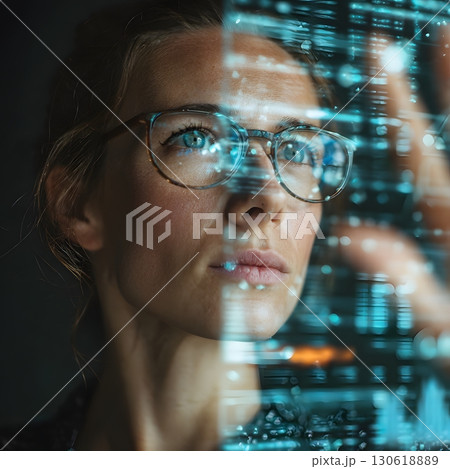 Businesswoman analyzing holographic AI data in modern office, professional tone, 16:9 130618889