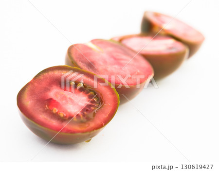 black halves of tomatoes on white background black halves of tomatoes on white background 130619427