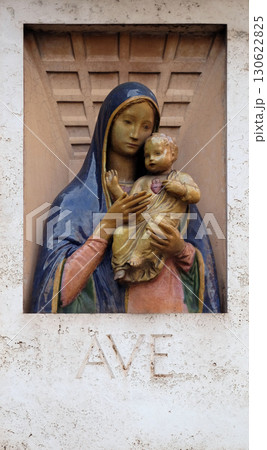 Ave Maria Image of Virgin Mary with baby Jesus on the facade of a palace in Rome, Italy 130622825