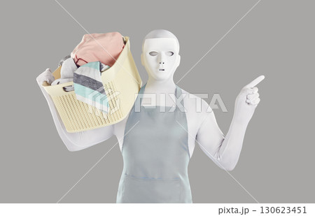Man in bodysuit disguise holding laundry basket, advertising detergent and pointing finger away 130623451