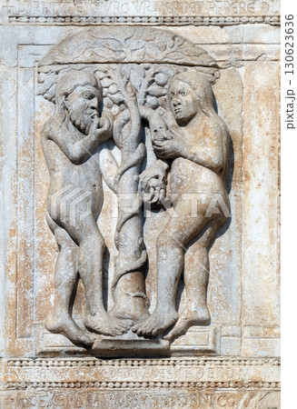 Adam and Eve eat the fruit of the forbidden tree, medieval relief on the facade of Basilica of San Zeno in Verona, Italy Adam and Eve eat the fruit of the forbidden tree, medieval relief on the facade of Basilica of San Zeno in Verona, Italy 130623636