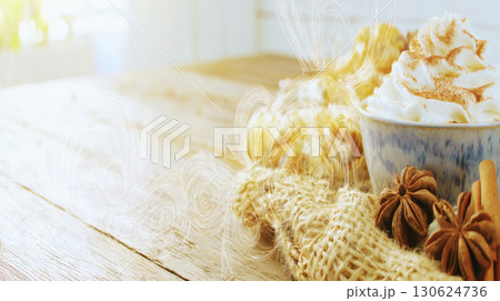 Photorealistic pumpkin spice latte with whipped cream and cinnamon on rustic wooden table in cozy autumn atmosphere perfect for seasonal coffee design warm drink advertising or fall campaign 130624736