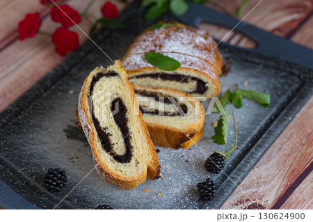 Sliced sweet roll with poppy seeds and blackberries Sliced sweet roll with poppy seeds and blackberries 130624900
