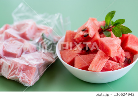 Fresh watermelon cubes in white bowl and frozen package 130624942