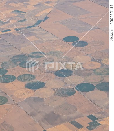 Aerial view of circular farmland patterns across rural landscape in Turkey. Agriculture, irrigation, and environmental management creating geometric scenery of cultivated earth from above. Aerial view of circular farmland patterns across rural landscape in Turkey. Agriculture, irrigation, and environmental management creating geometric scenery of cultivated earth from above. 130625133