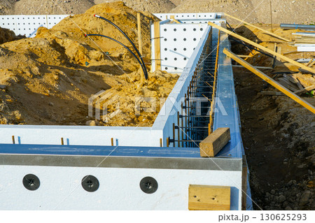 ICF foundation wall with rebar reinforcement during construction on modern building site 130625293