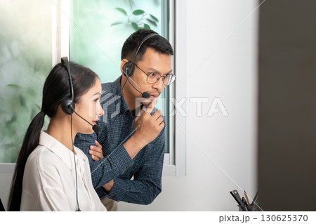 Focused Call Center Agents Engaging in Customer Interaction 130625370