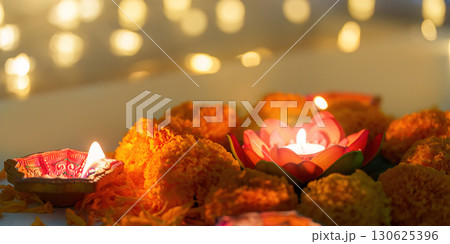 Diwali Festival. Colorful candles and marigold flowers creating a festive atmosphere. Diwali Festival. Colorful candles and marigold flowers creating a festive atmosphere. 130625396