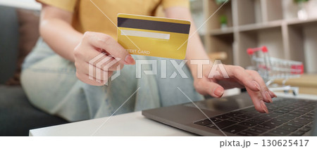 Cyber Monday Online Shopping. Woman with credit card making purchases on laptop. 130625417