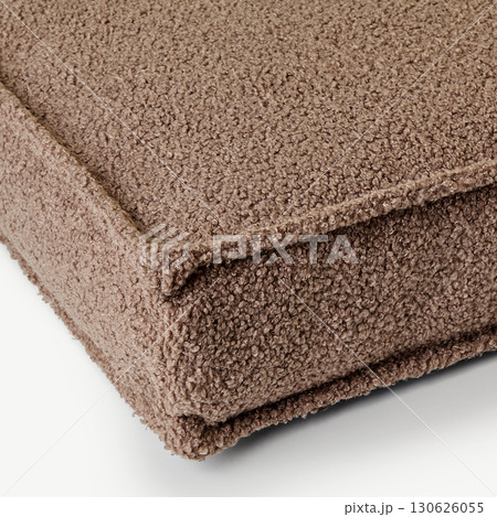 Close-up of corner of soft brown boucle cushion showing texture Close-up of corner of soft brown boucle cushion showing texture 130626055