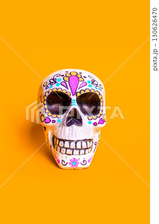 Painted skull for mexican Dia De Los Muertos holiday on orange background 130626470