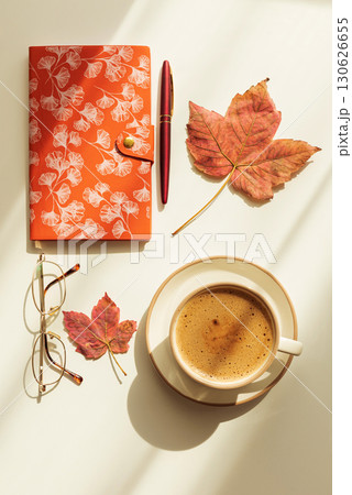 Autumn Flat Lay with Notebook, Coffee, Leaves and Eyeglasses under Sun Light Autumn Flat Lay with Notebook, Coffee, Leaves and Eyeglasses under Sun Light 130626655