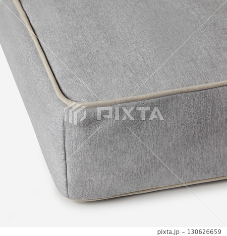 Corner of gray mattress with beige piping detailing on white background Corner of gray mattress with beige piping detailing on white background 130626659