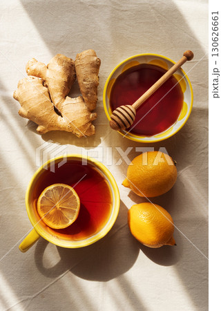Flat Lay with Lemon Tea, Ginger and Honey on Light Table under Sun Light Flat Lay with Lemon Tea, Ginger and Honey on Light Table under Sun Light 130626661