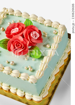 Delicious square cake decorated with fondant roses and pearls for a celebration Delicious square cake decorated with fondant roses and pearls for a celebration 130626686