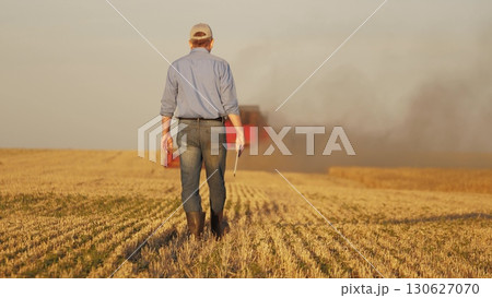 farmer working in wheat field, combine harvester ploughing in wheat field, agriculture tablet, enhancing decision making with data, revolutionizing agricultural practices, efficient resource farmer working in wheat field, combine harvester ploughing in wheat field, agriculture tablet, enhancing decision making with data, revolutionizing agricultural practices, efficient resource 130627070