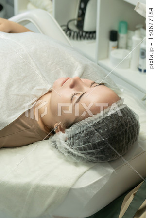 Facial Treatment, Spa, Woman: Relaxation, Skincare procedure, Beauty salon, patient lying down. Facial Treatment, Spa, Woman: Relaxation, Skincare procedure, Beauty salon, patient lying down. 130627184
