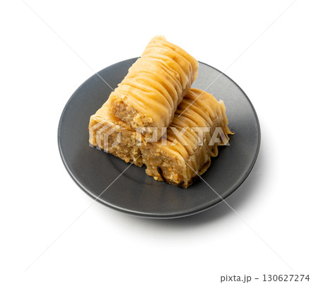 Rolled Baklava Isolated, Ramadan Dessert Roll on Restaurant Plate, Eastern Sweet Pastries Rolled Baklava Isolated, Ramadan Dessert Roll on Restaurant Plate, Eastern Sweet Pastries 130627274