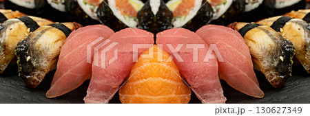 Set of Various Japanese Sushi Food on Dark Sate Plate Closeup. Nigiri and Nori Maki Sushi Rolls 130627349