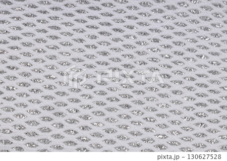 Close up of white mesh fabric with silver detail Close up of white mesh fabric with silver detail 130627528