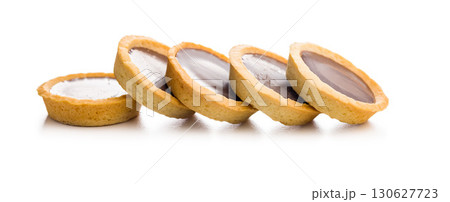 Sweet chocolate tartelettes isolated on white background. Sweet chocolate tartelettes isolated on white background. 130627723