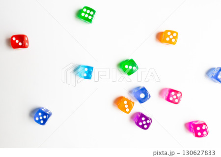 Colorful assorted dice scattered on white surface 130627833