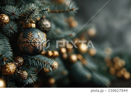 Close-up of a Christmas tree with gold and green balls on it. Blurred abstract background with space for text. 130627844