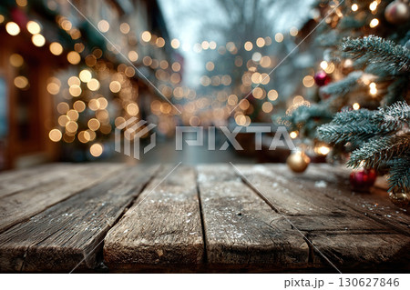 Wooden stage with Christmas fir branches on the right and space for product display. Blurred city background with golden bokeh. Christmas time. 130627846