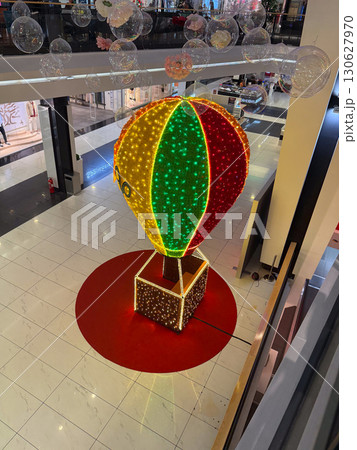 Large balloon sculpture with glowing lights placed in shopping mall. Public decoration, festive installation and entertainment culture with creative display and holiday atmosphere. 130627970